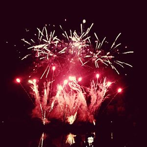 Low angle view of firework display at night