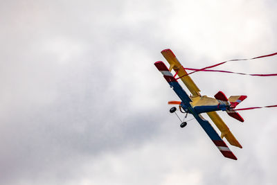 Low angle view of airplane flying against sky