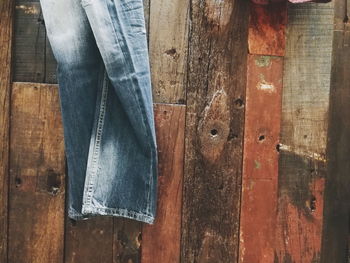 Low section of man standing on wooden floor
