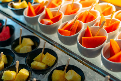 Tropical fruit buffet at event in restaurant. catering food. fresh papaya, pineapple and watermelon.