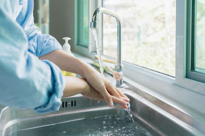 Midsection of man washing hands