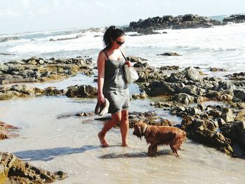 Full length of woman standing on beach