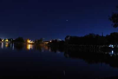 Scenic view of lake against sky at night