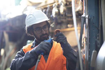 Young store worker cleaning a tool