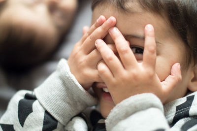 Close-up portrait of boy with hands