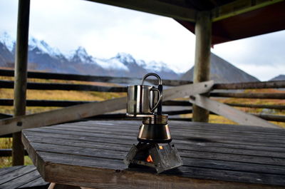 Close-up of railing on table against mountains