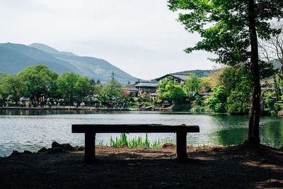 Gazebo by lake against sky