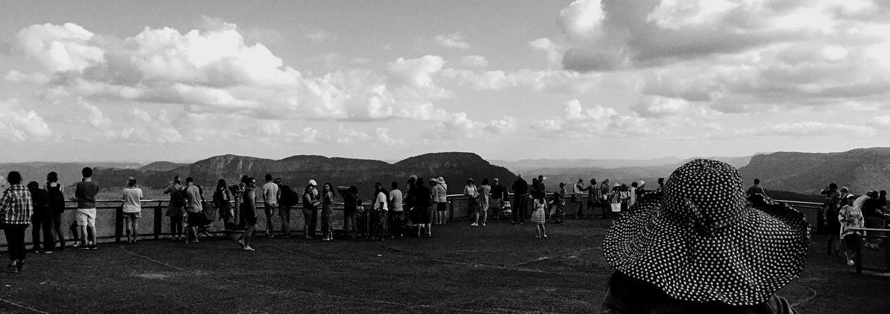 sky, cloud - sky, cloudy, beach, sand, cloud, sea, built structure, architecture, panoramic, men, day, fence, person, nature, outdoors, large group of people, tourism, scenics