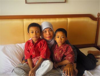 Portrait of siblings sitting at home