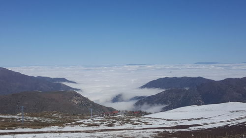 Scenic view of snowcapped mountains against clear blue sky