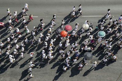 High angle view of people walking on road