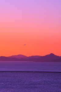 Scenic view of sea against orange sky