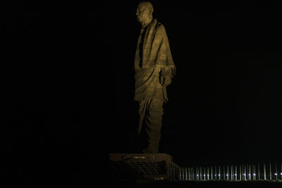 Low angle view of statue against black background