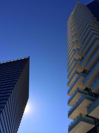 Low angle view of buildings against clear blue sky