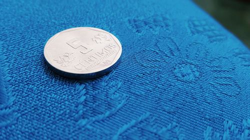 Close-up of coins on blue surface