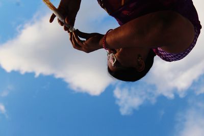 Low angle view of man and woman against sky