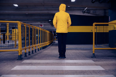 Rear view of man standing on footpath