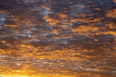 Low angle view of dramatic sky during sunset