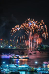 Firework display in city at night