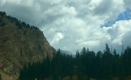 Panoramic view of trees and mountains against sky