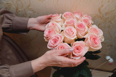 Midsection of bride holding bouquet