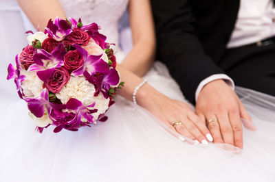 Midsection of bride and groom during wedding