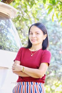 Portrait of woman standing with arms crossed 