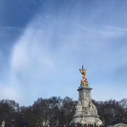 Low angle view of statue against cloudy sky
