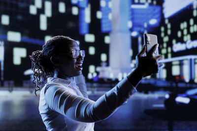 Side view of woman looking at music concert