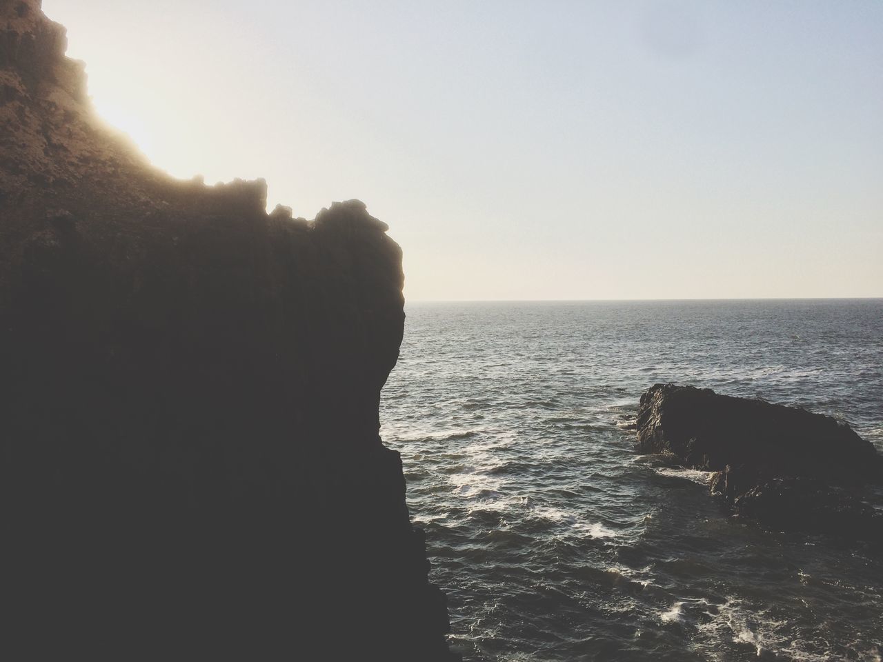 sea, sky, water, rock, scenics - nature, beauty in nature, horizon over water, horizon, tranquility, nature, rock - object, solid, tranquil scene, land, clear sky, beach, copy space, rock formation, no people, outdoors, stack rock