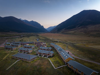 High angle view of townscape and mountains against sky