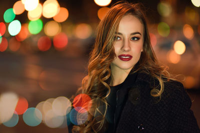 Beautiful young woman standing in city