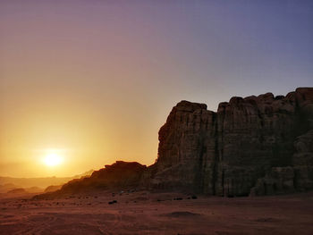 Scenic view of rock formations against sky during sunset