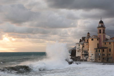 Scenic view of sea against buildings