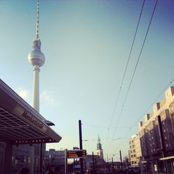 Low angle view of communications tower against blue sky