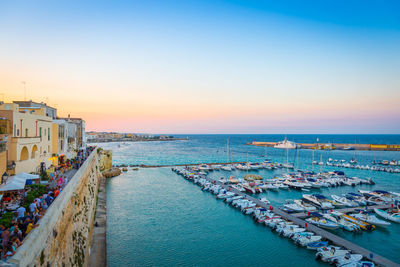 High angle view of city by sea against clear sky