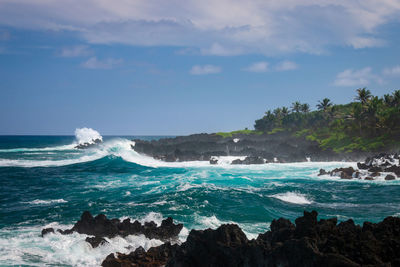 Scenic view of rough black coastline at waianapanapa state park, maui, hawaii against sky