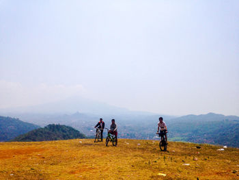 People on mountain road against sky