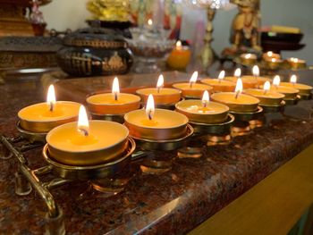 Close-up of lit candles in temple