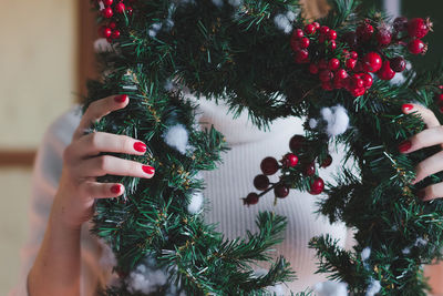 Close-up of wreath held by woman