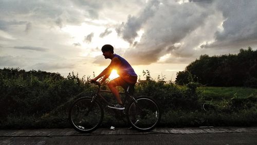 Bicycle on road against sky during sunset