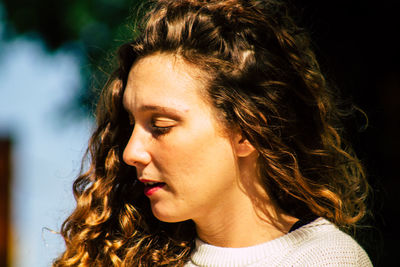 Close-up portrait of young woman looking away