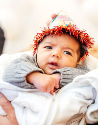 Portrait of cute baby lying on bed