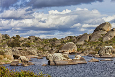 Rocks on beach against sky