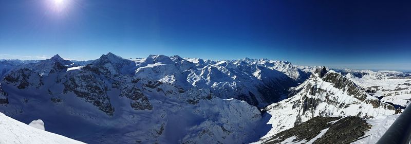 Scenic view of snow covered mountains against clear sky