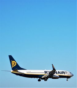 Airplane flying against clear blue sky