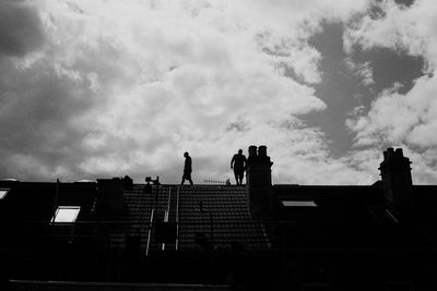 Low angle view of silhouette buildings against sky