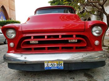 Red car parked against wall