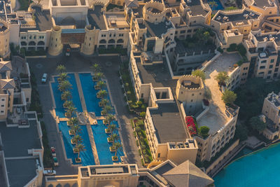 High angle view of swimming pool by buildings in city