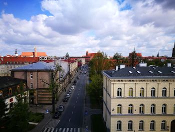 View of cityscape against cloudy sky